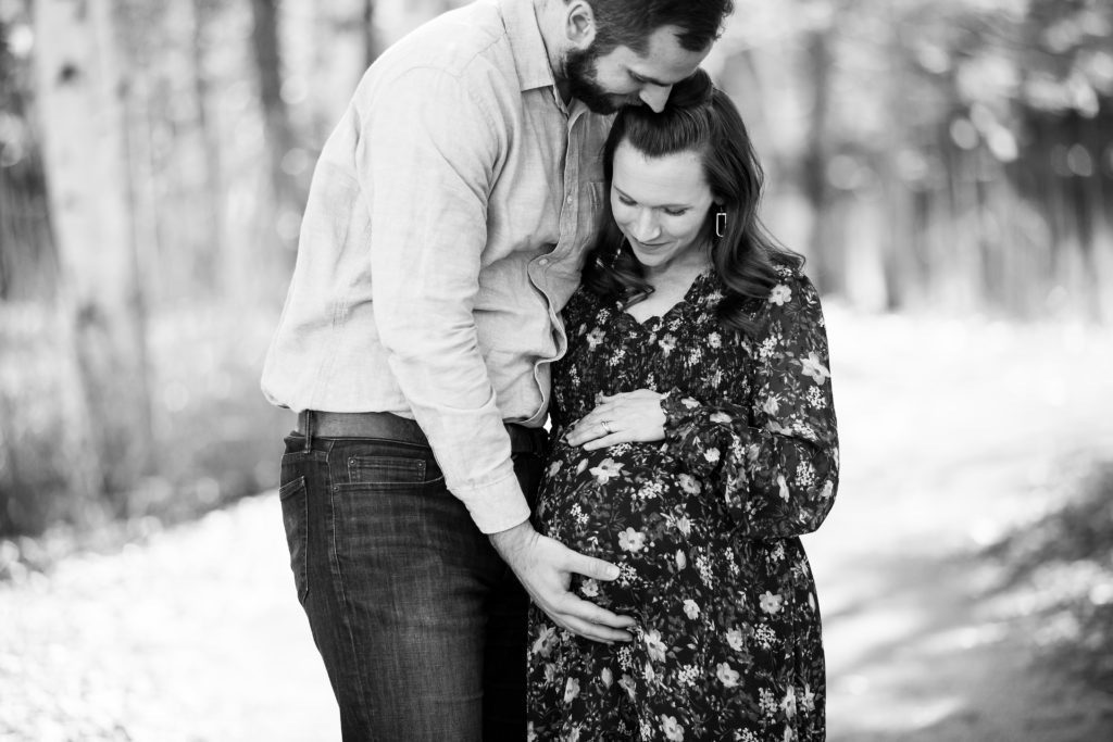 husband and wife maternity photo hands on belly 