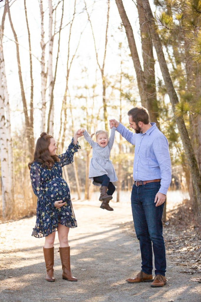 toddler swinging between mom and dad maternity session 