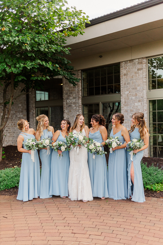 bride and bridesmaids looking at eachother cute bridal portrait 