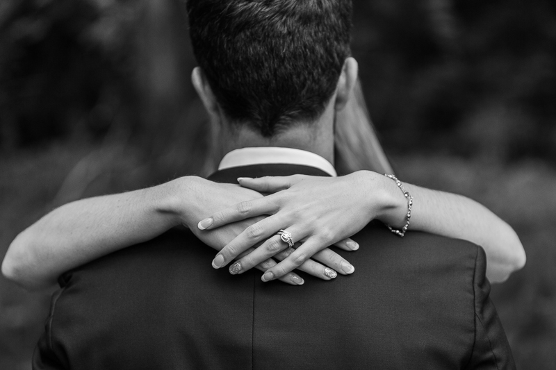 black and white vignette of bride with her arms around groom's neck in green bay wedding